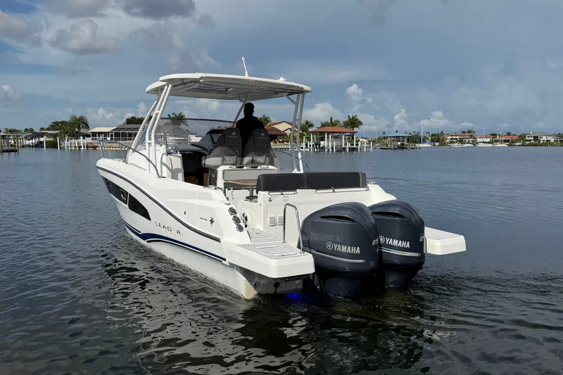 Slide: The Image of 2021 Jeanneau Cap Camarat 9.0 WA boat with twin Yamaha engines on calm water. - 2