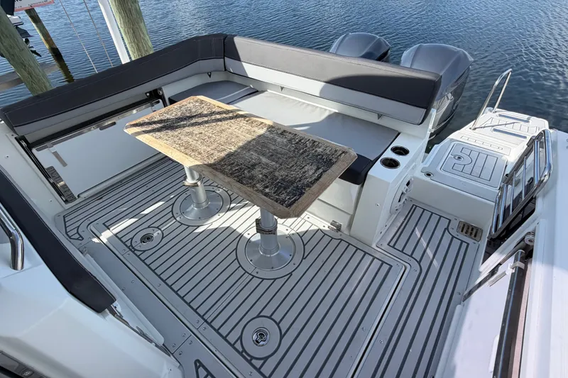 Slide: The Image of Jeanneau Cap Camarat 9.0 WA 2021 boat deck with seating and wooden table. - 23