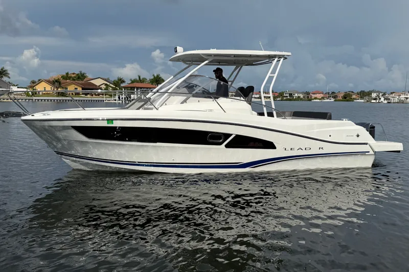 Slide: The Image of 2021 Jeanneau Cap Camarat 9.0 WA boat on calm water, side view. - 5