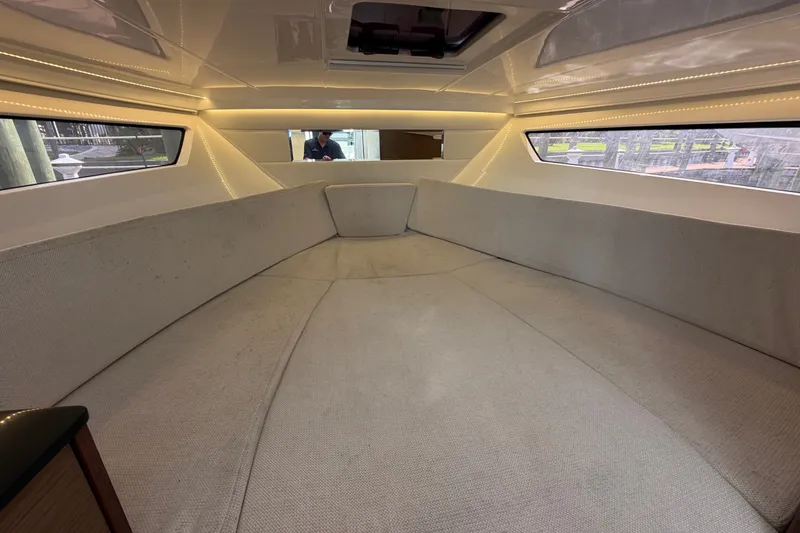 Slide: The Image of Interior cabin of 2021 Jeanneau Cap Camarat 9.0 WA with spacious seating and windows. - 14