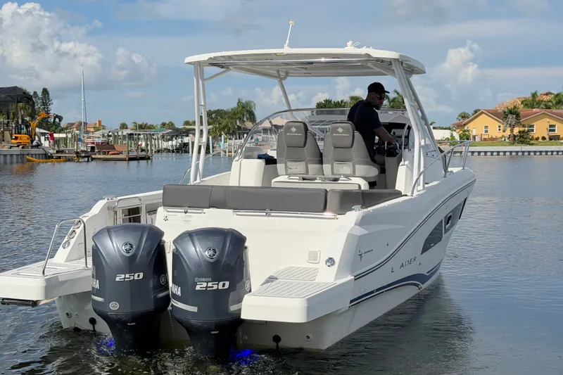 Slide: The Image of 2021 Jeanneau Cap Camarat 9.0 WA boat with dual Yamaha 250 engines on a calm waterway. - 3