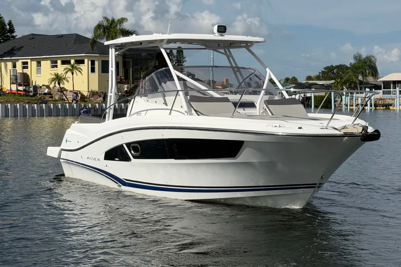 Slide: The Image of 2021 Jeanneau Cap Camarat 9.0 WA boat on calm water near waterfront homes. - 8