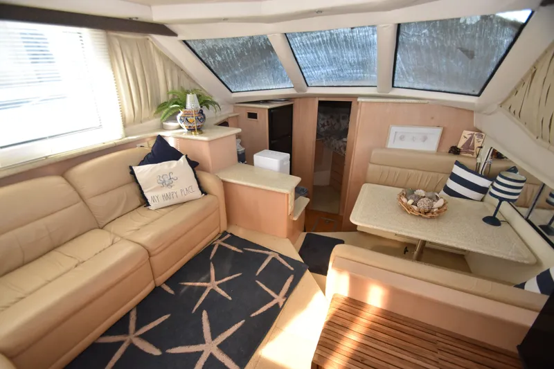 Slide: The Image of Interior of the 2000 Carver 356 Aft Cabin Motor Yacht with beige sofa and dining table. - 6