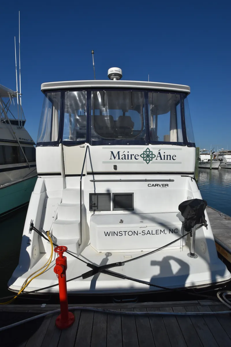 Slide: The Image of 2000 Carver 356 Aft Cabin Motor Yacht docked at a marina. - 1