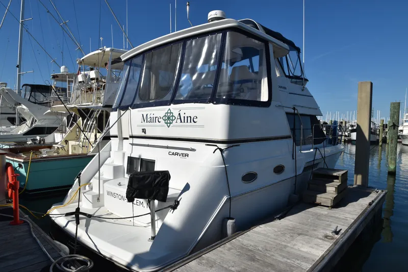 Slide: The Image of 2000 Carver 356 Aft Cabin Motor Yacht docked at a marina. - 2