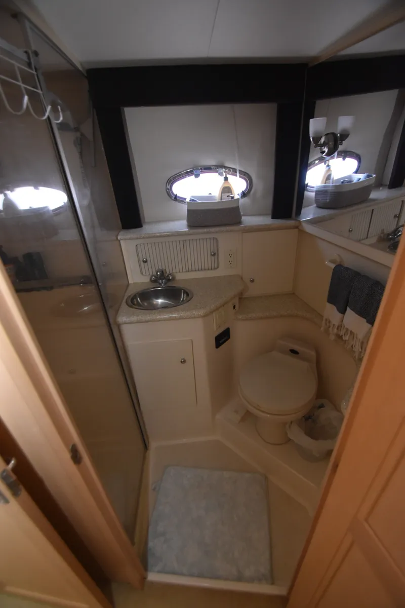 Slide: The Image of The image shows a yacht bathroom with a sink, toilet, and shower. - 14