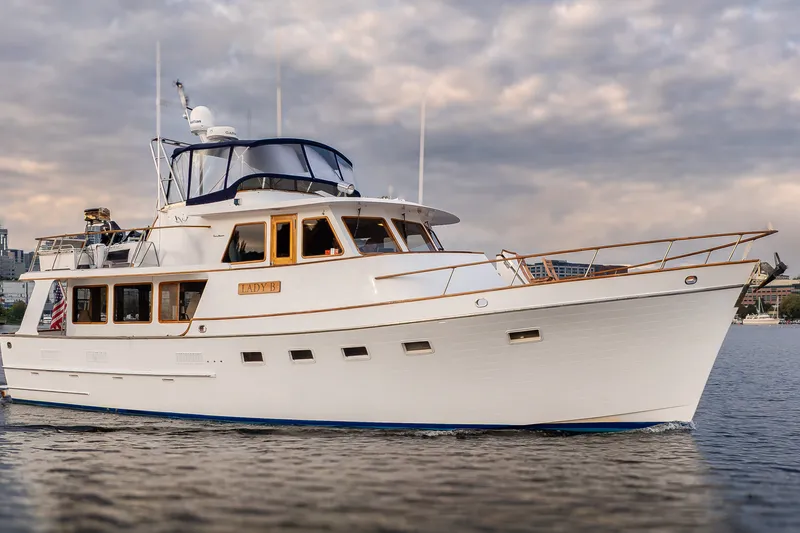 Slide: The Image of 1992 Ocean Alexander 50 Mark I yacht cruising on calm waters under cloudy skies. - 39