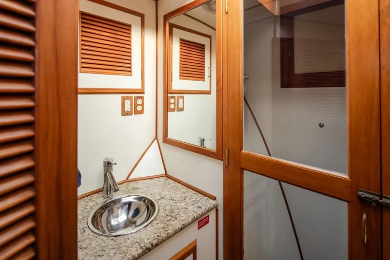 Slide: The Image of Elegant bathroom interior of 1982 Ocean Alexander 50 Mark I yacht, featuring wood accents and granite countertop. - 27