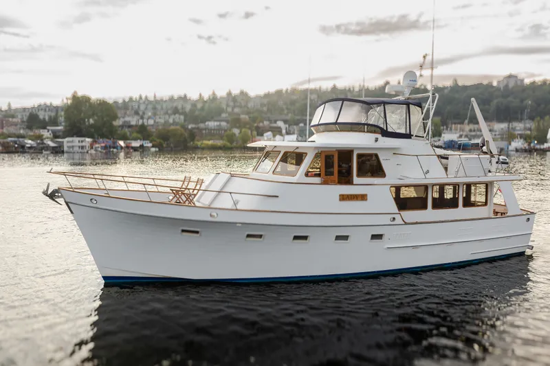 Slide: The Image of 1992 Ocean Alexander 50 Mark I yacht on calm water, scenic background. - 3