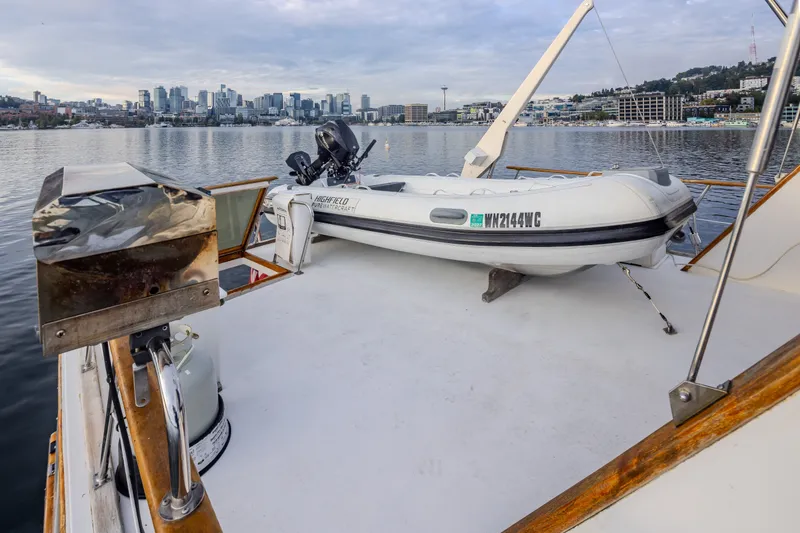 Slide: The Image of 1982 Ocean Alexander 50 Mark I yacht with dinghy, city skyline in background. - 34