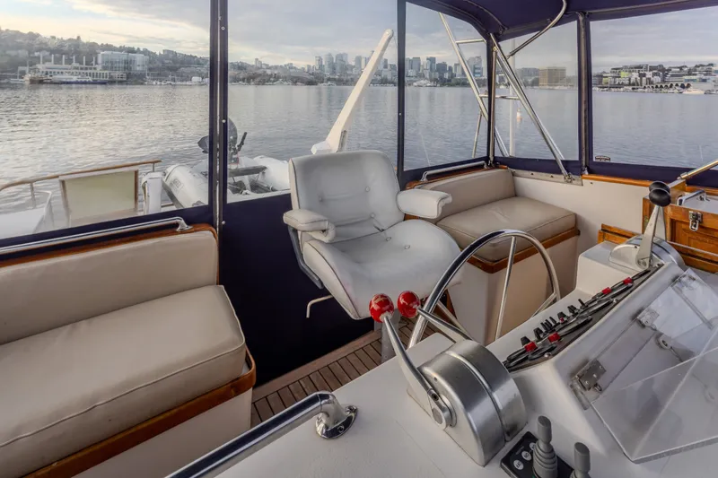 Slide: The Image of Interior view of 1982 Ocean Alexander 50 Mark I yacht helm with cityscape background. - 30