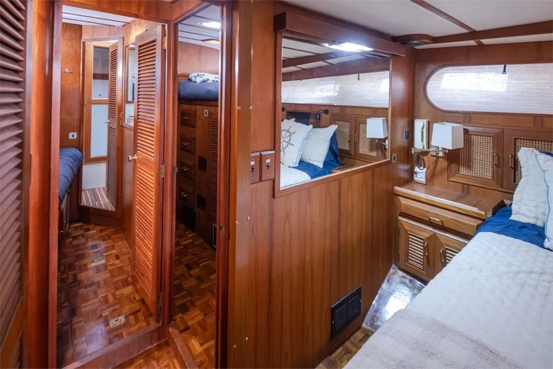 Slide: The Image of Luxurious 1982 Ocean Alexander 50 Mark I yacht interior with wood paneling and cozy bedding. - 22