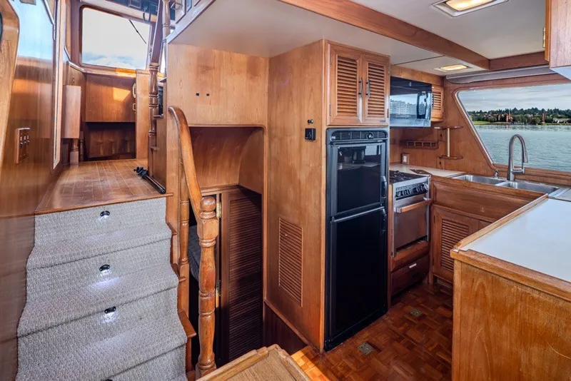 Slide: The Image of Interior of 1982 Ocean Alexander 50 Mark I yacht with wooden cabinetry and kitchen area. - 14