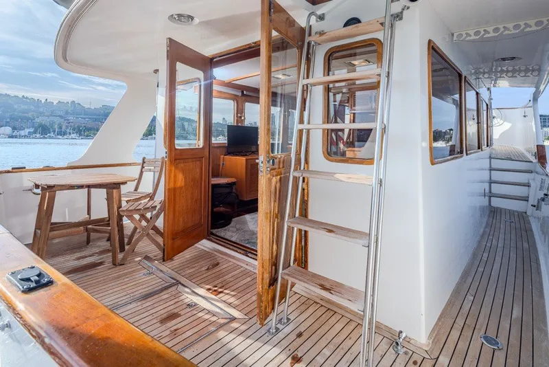 Slide: The Image of Ocean Alexander 50 Mark I yacht deck with wooden furniture and ladder, 1982 model. - 44