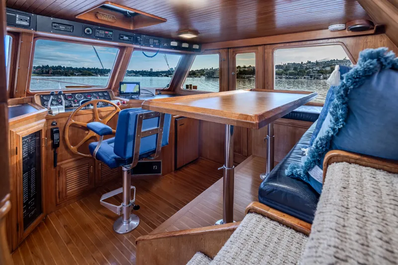 Slide: The Image of Interior of 1982 Ocean Alexander 50 Mark I yacht with wooden helm and seating area. - 15