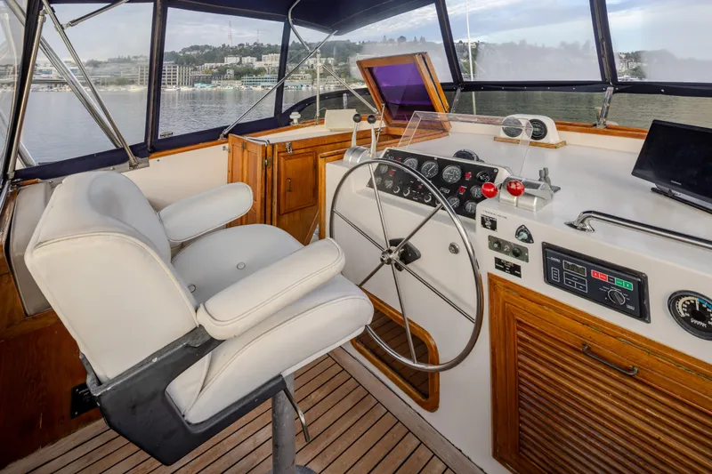 Slide: The Image of Cockpit of 1982 Ocean Alexander 50 Mark I yacht with steering wheel and control panel. - 32