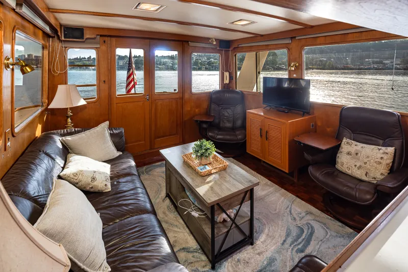 Slide: The Image of Luxurious 1982 Ocean Alexander 50 Mark I yacht interior with leather seating and scenic water views. - 9