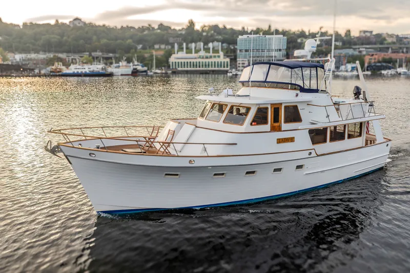 Slide: The Image of 1982 Ocean Alexander 50 Mark I yacht cruising on serene waters at sunset. - 43