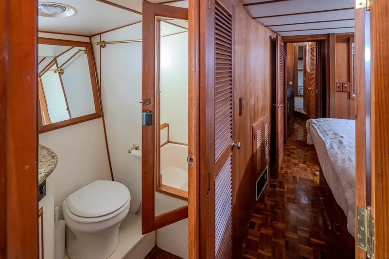 Slide: The Image of Interior of 1982 Ocean Alexander 50 Mark I yacht, featuring wooden finishes and compact bathroom. - 21