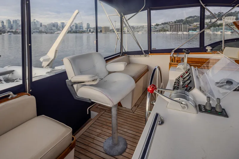 Slide: The Image of Interior view of 1982 Ocean Alexander 50 Mark I yacht helm with city skyline backdrop. - 29