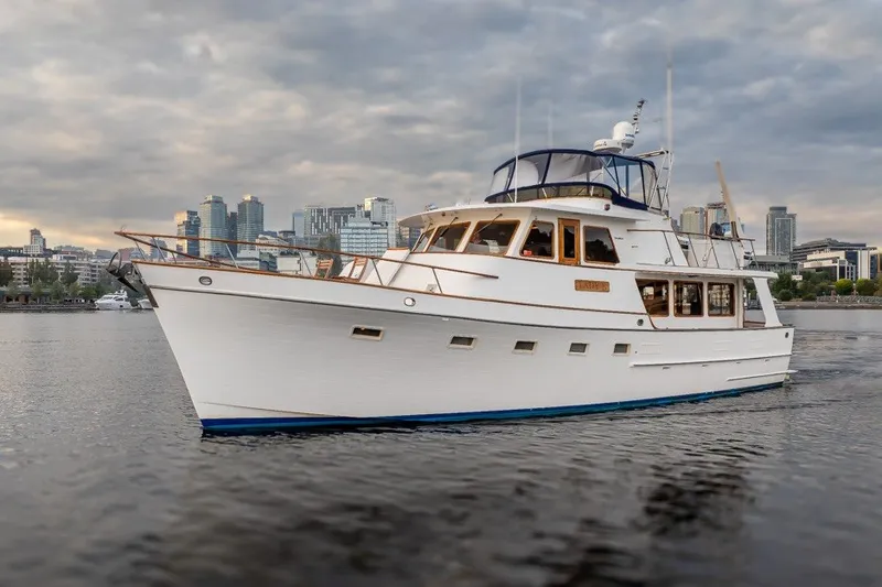 Slide: The Image of 1982 Ocean Alexander 50 Mark I yacht on water with city skyline backdrop. - 42
