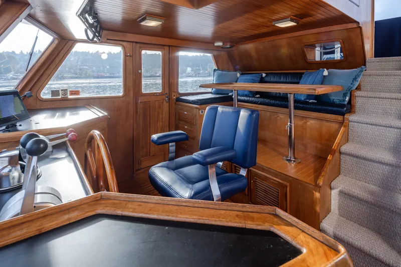 Slide: The Image of Interior of 1982 Ocean Alexander 50 Mark I yacht with wood finish and blue seating. - 16
