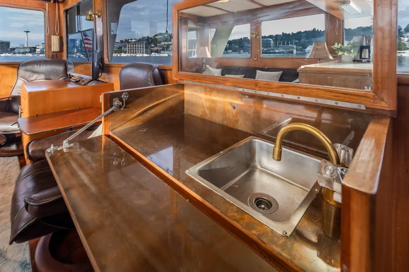Slide: The Image of Interior of 1982 Ocean Alexander 50 Mark I yacht with sink and seating area. - 12