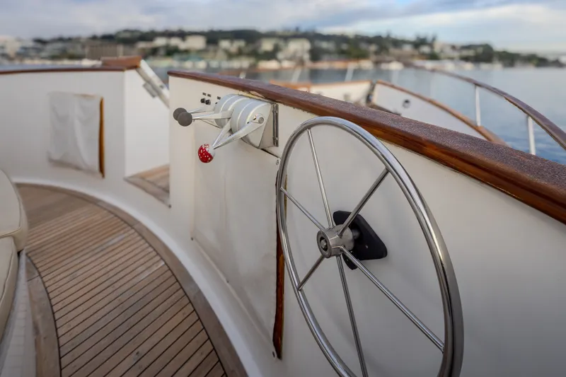Slide: The Image of Steering wheel of 1982 Ocean Alexander 50 Mark I yacht with wooden deck. - 36