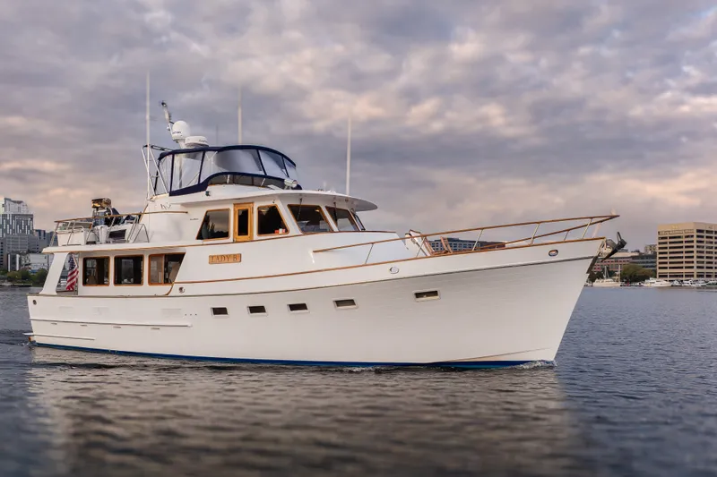 Slide: The Image of 1992 Ocean Alexander 50 Mark I yacht cruising on calm waters under a cloudy sky. - 1
