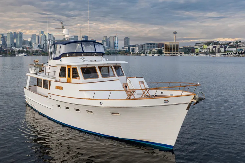 Slide: The Image of Ocean Alexander 50 Mark I yacht, 1992 model, cruising near a city skyline with iconic tower. - 5