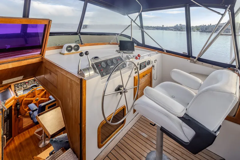 Slide: The Image of Cockpit of 1982 Ocean Alexander 50 Mark I yacht with steering wheel and white captain's chair. - 31