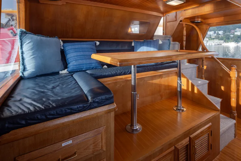 Slide: The Image of Interior of 1982 Ocean Alexander 50 Mark I yacht with wooden finish and blue cushions. - 17