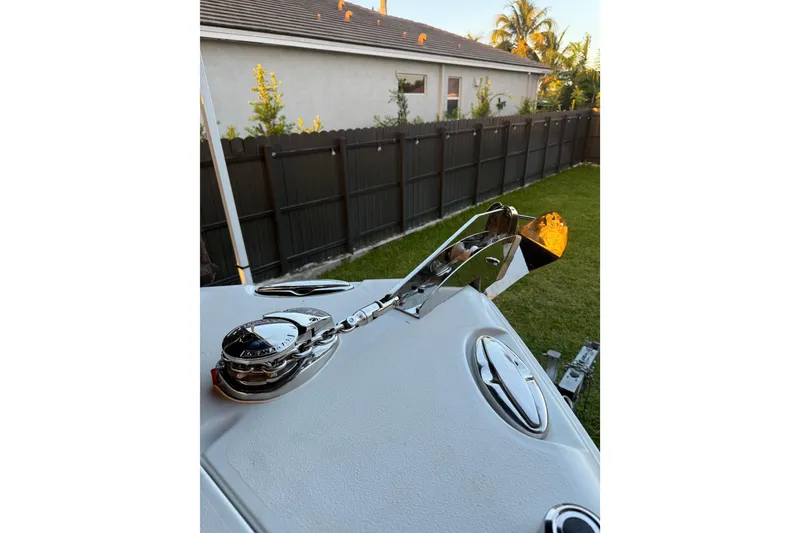 Slide: The Image of 2016 Sea Hunt Gamefish 25 boat anchor system with chrome finish, in a residential backyard. - 34