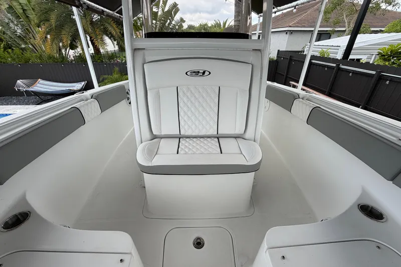 Slide: The Image of 2016 Sea Hunt Gamefish 25 boat interior with white seating and sleek design. - 31