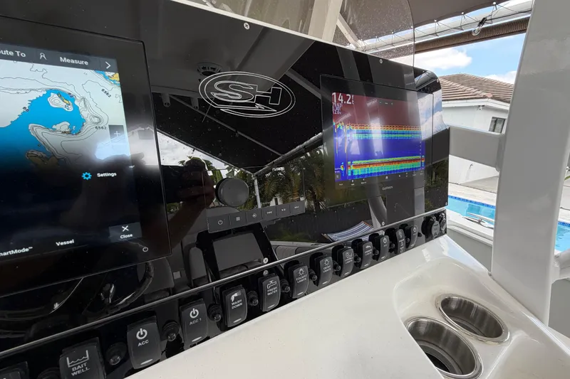 Slide: The Image of 2016 Sea Hunt Gamefish 25 dashboard with navigation and sonar displays. - 18