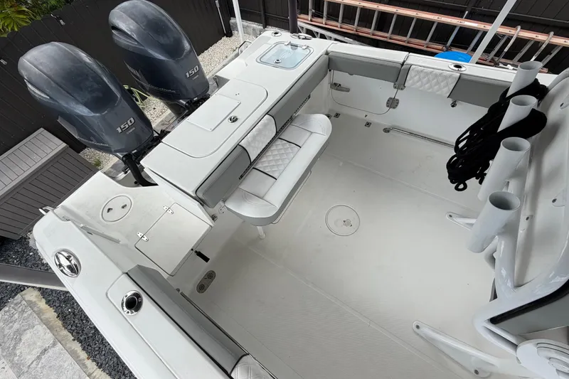 Slide: The Image of 2016 Sea Hunt Gamefish 25 boat interior with dual 150 engines and fishing rod holders. - 11