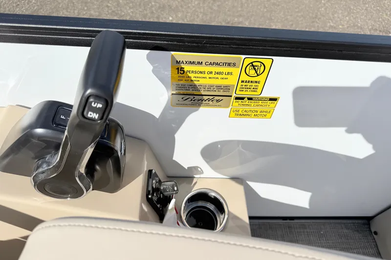 Slide: The Image of Control panel of 2027 Bentley Pontoons Legacy 223 Navigator with capacity warning labels. - 13