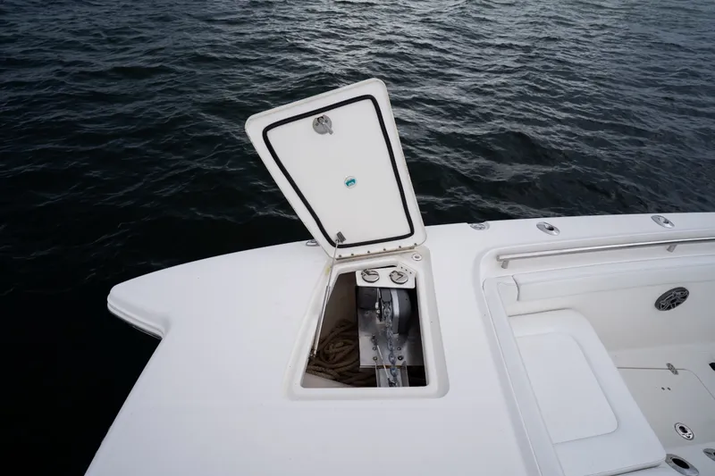 Slide: The Image of 2021 World Cat 400 CC-X boat with open storage compartment on calm water. - 24