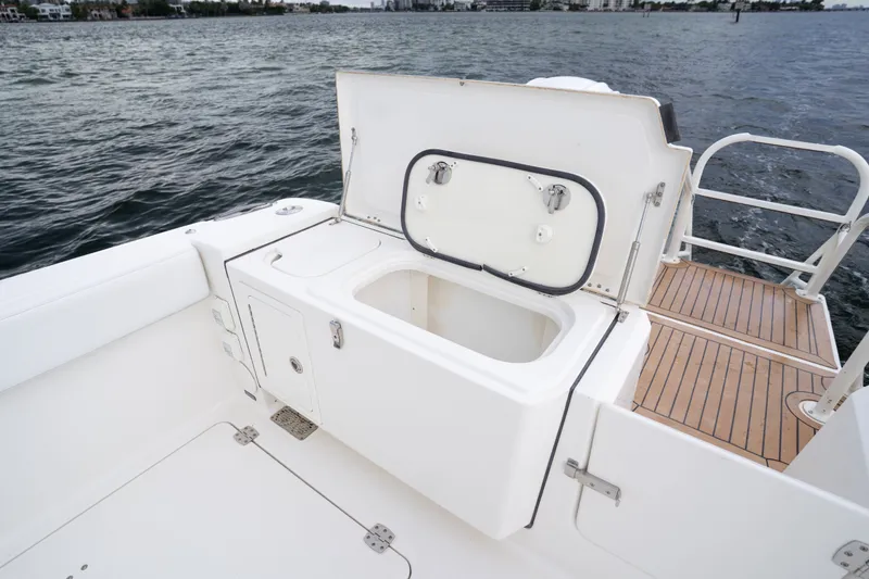 Slide: The Image of Open storage compartment on 2021 World Cat 400 CC-X boat deck by the water. - 14