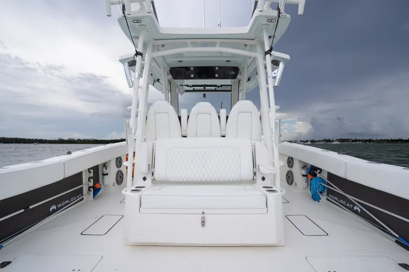 Slide: The Image of 2021 World Cat 400 CC-X boat interior with seating, ocean backdrop, and overcast sky. - 9
