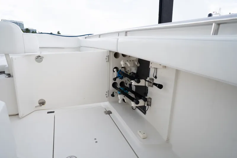 Slide: The Image of 2021 World Cat 400 CC-X boat interior with open storage compartment and fishing rod holders. - 27