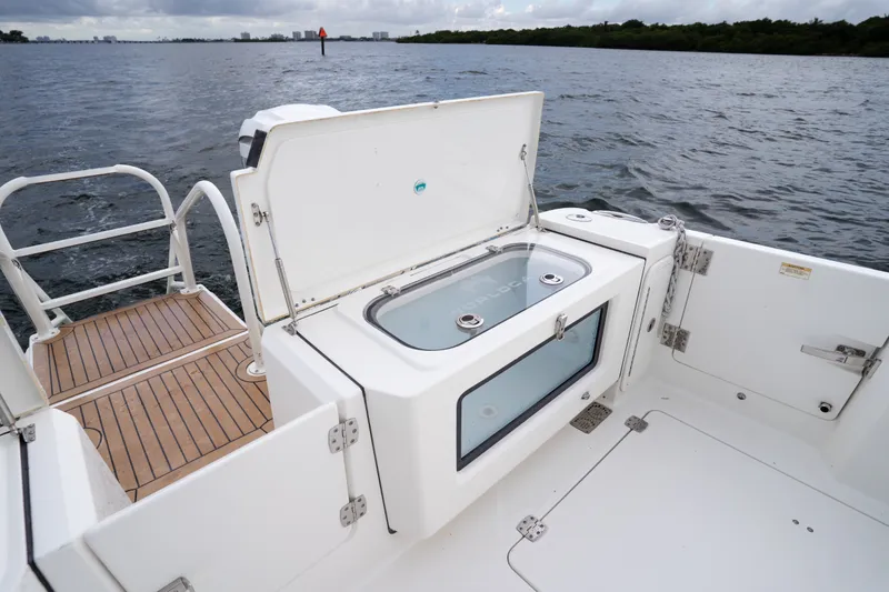 Slide: The Image of 2021 World Cat 400 CC-X boat with open storage compartment on deck. - 13