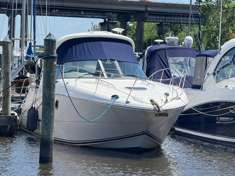 Slide: The Image of 2008 Sea Ray 330 Sundancer yacht docked at marina, featuring sleek design and blue canopy. - 4