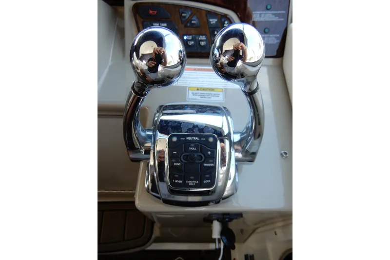 Slide: The Image of Chrome throttle controls on a 2008 Sea Ray Sundancer 330 yacht dashboard. - 34