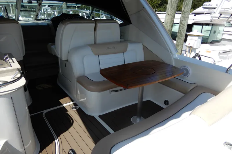 Slide: The Image of 2008 Sea Ray Sundancer 330 interior with seating and wooden table. - 11
