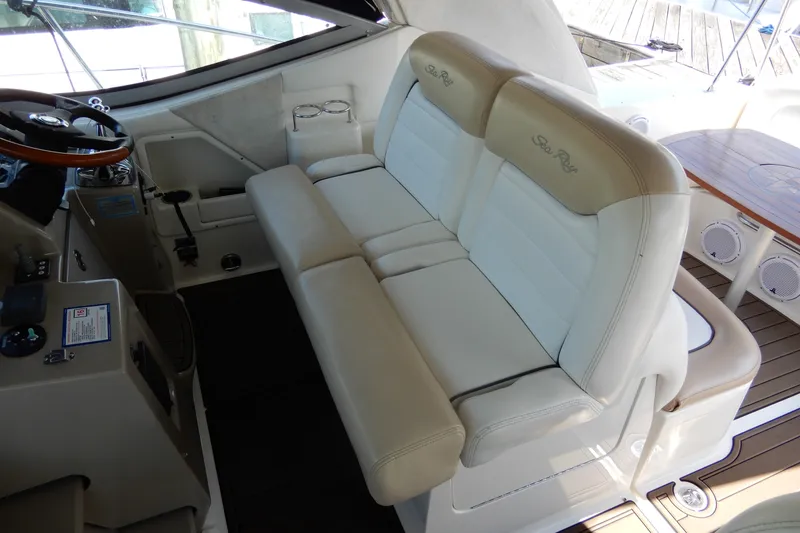 Slide: The Image of Interior of 2008 Sea Ray Sundancer 330 with beige seating and helm controls. - 26