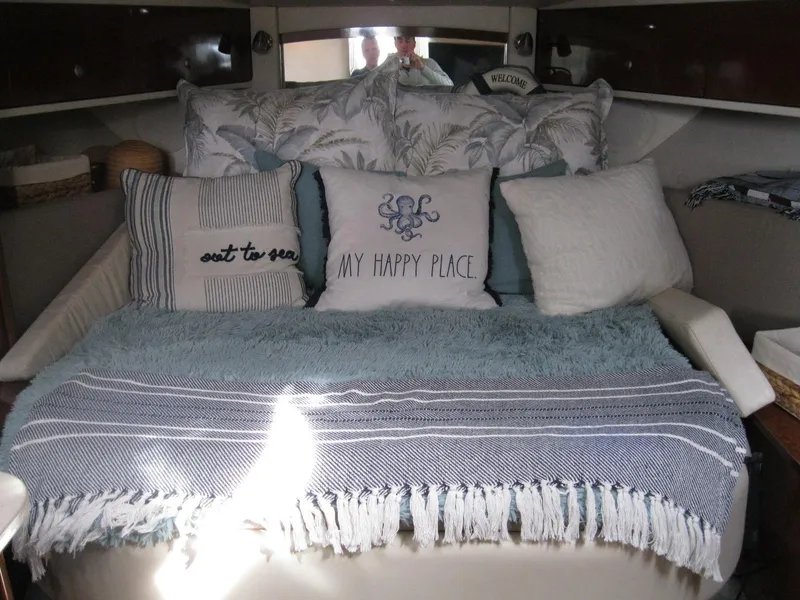 Slide: The Image of Cozy cabin interior of 2008 Sea Ray 330 Sundancer with decorative pillows and blanket. - 40