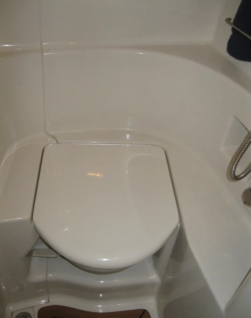Slide: The Image of 2008 Sea Ray 330 Sundancer boat bathroom with compact toilet and shower. - 55