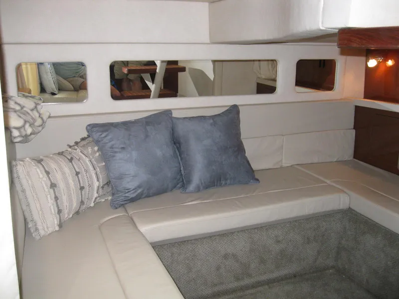 Slide: The Image of Interior of 2008 Sea Ray 330 Sundancer with cozy seating and decorative pillows. - 50