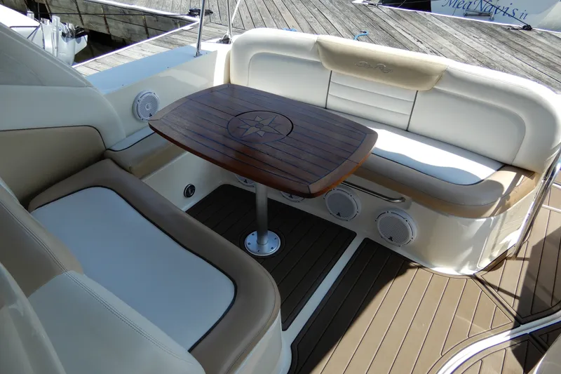 Slide: The Image of Luxurious seating area on 2008 Sea Ray Sundancer 330 yacht with wooden table. - 14